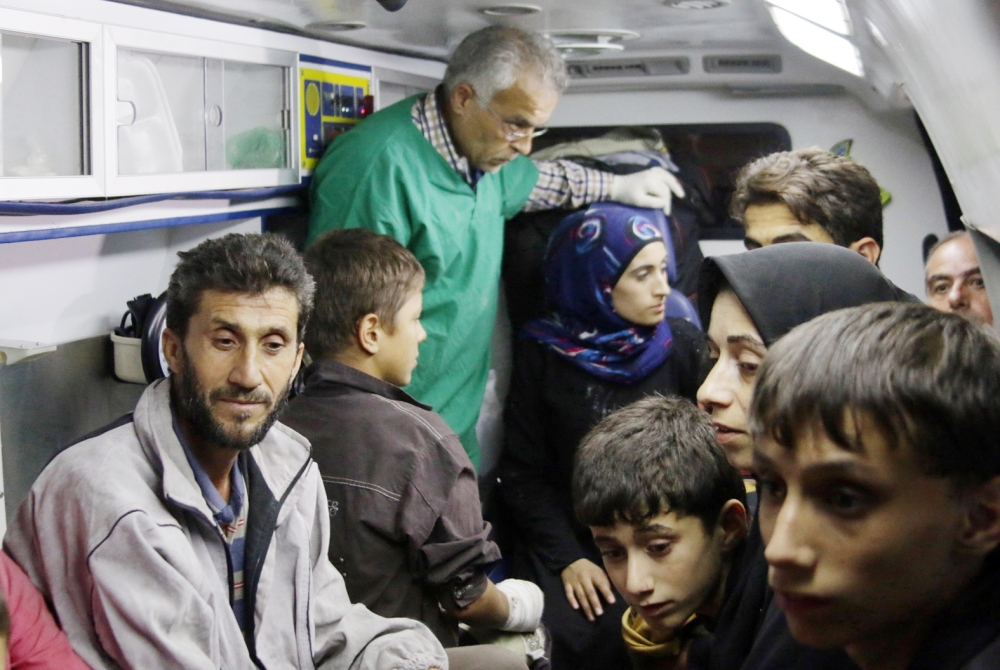 Syrians who were living in the rebel-held side of Aleppo are seen inside an ambulance after nearly 50 people fled the rebel held eastern districts of the battered city into the government-controlled west on October 24, 2016. 

 The incident comes after a unilateral three-day ceasefire declared by Russia and government forces ended on Sunday without any evacuations by the United Nations. 