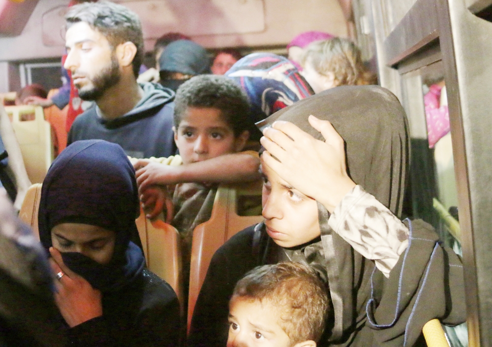 Syrians who were living in the rebel-held side of Aleppo are seen inside a vehicle after nearly 50 people fled the rebel held eastern districts of the battered city into the government-controlled west on October 24, 2016. 

 The incident comes after a unilateral three-day ceasefire declared by Russia and government forces ended on Sunday without any evacuations by the United Nations. 