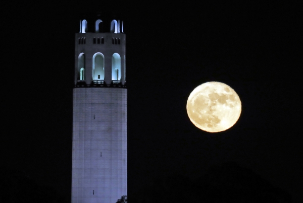 The supermoon rises over Coit Tower in San Francisco, Monday, Nov. 14, 2016. The brightest moon in almost 69 years is lighting up the sky in a treat for star watchers around the globe. The phenomenon known as the supermoon reached its peak luminescence in North America before dawn on Monday. Its zenith in Asia and the South Pacific was Monday night. (AP Photo/Marcio Jose Sanchez)