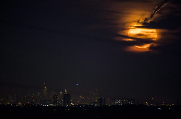 The moon rises over the Toronto skyline as viewed from Milton, Ontario, on Monday, Nov. 14, 2016. (Mark Blinch/The Canadian Press via AP)