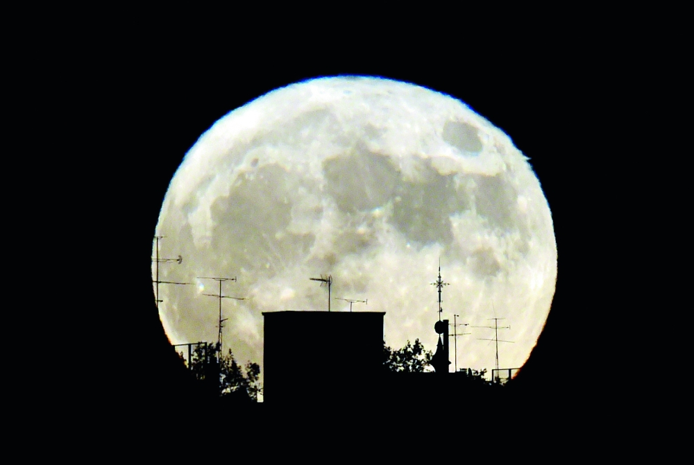 TOPSHOT - A Supermoon rises against the skyline in Madrid on November 14, 2016.   The phenomenon happens when the moon is full at the same time as, or very near, perigee -- its closest point to Earth on an elliptical, monthly orbit. It was the closest to Earth since 1948 at a distance of 356,509 kilometres (221,524 miles), creating what NASA described as 