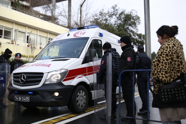 A ambulance believed to carry a victim leaves the area as Turkish police officers block the road leading to the scene of an attack in Istanbul, early Sunday, Jan. 1, 2017. An assailant believed to have been dressed in a Santa Claus costume opened fire at a crowded nightclub in Istanbul during New Year's celebrations, killing dozens of people and wounding tens of others in what the province's governor described as a terror attack. (AP Photo/Emrah Gurel)