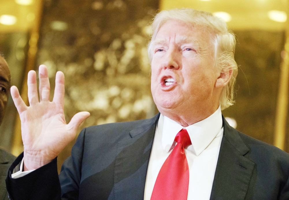 FILE - In this Jan. 13, 2017 file photo, President-elect Donald Trump speaks with reporters in the lobby of Trump Tower in New York. Trump has offered views on U.S. relations with Asia that could indicate radical shifts in long-standing policy toward the region. From opposing free trade agreements to confronting China and questioning Japan-South Korea alliances, he appears set to be charting a course far different from previous administrations. (AP Photo/Evan Vucci, File)