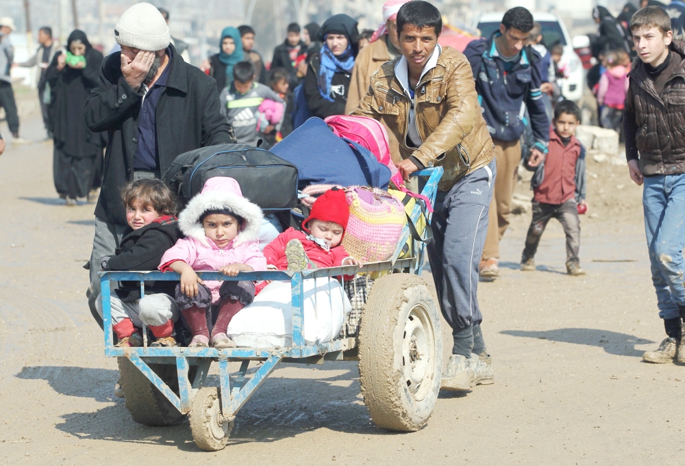 نازحون عراقيون يسيرون نحو مخيمات اللاجئين بعد فرارهم من الموصل أمس. (أ. ف. ب) 