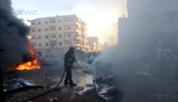 A still image taken from a video posted to a social media website on June 24, 2017, shows a civil defence member trying to put out a fire at the site of a car bomb, said to be in the town of al-Dana, in Syria's rebel-held Idlib province. Social Media Website via Reuters TV ATTENTION EDITORS - THIS IMAGE HAS BEEN SUPPLIED BY A THIRD PARTY. IT HAS BEEN CHECKED BY REUTERS' SOCIAL MEDIA TEAM AND REVIEWED BY A SENIOR EDITOR. REUTERS IS CONFIDENT THE EVENTS PORTRAYED ARE GENUINE FOR. NO RESALES. NO ARCHIVES TPX IMAGES OF THE DAY