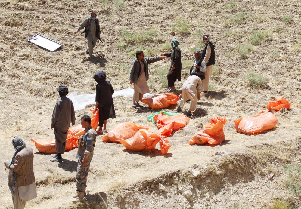 ATTENTION EDITORS - VISUAL COVERAGE OF SCENES OF INJURY OR DEATH  Villagers collect the dead bodies of civilians who were killed by insurgents at Mirza Olang village, in Sar-e Pul province, Afghanistan August 15, 2017. Picture taken August 15, 2017. REUTERS/Stringer NO RESALES. NO ARCHIVES