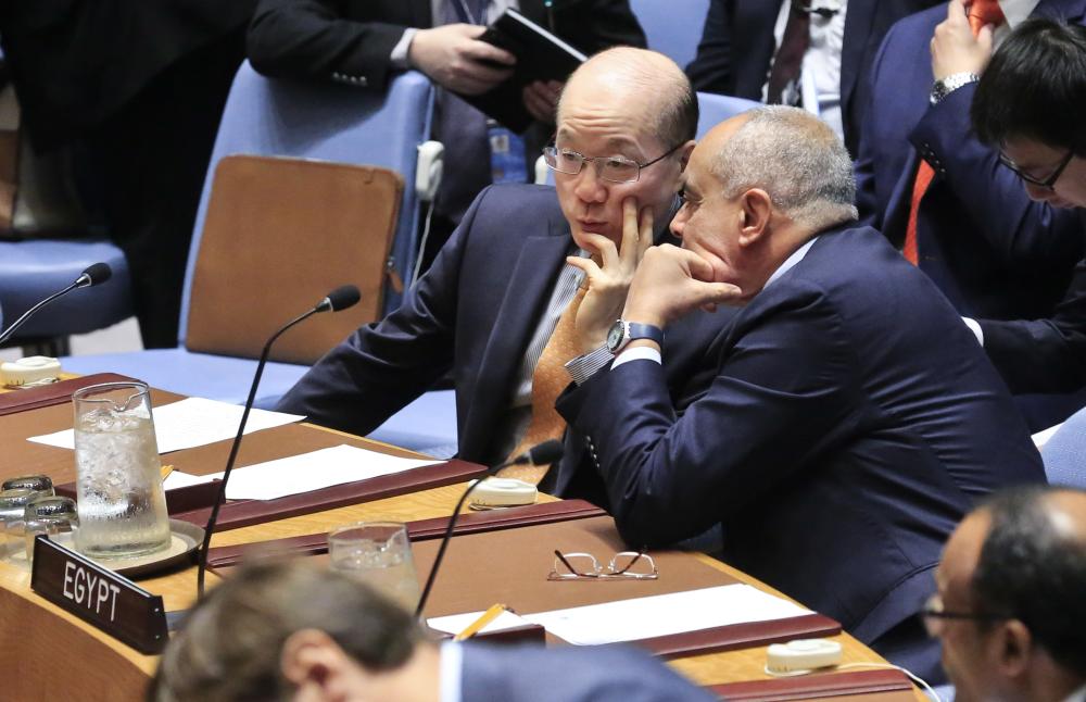 United Nations Ambassadors Liu Jieyi of China, left, and Abdellatif Aboulatta of Egypt, right, confer during U.N. Security Council's non-proliferation meeting on North Korea , Monday Sept. 4, 2017, at U.N. headquarters. (AP Photo/Bebeto Matthews)