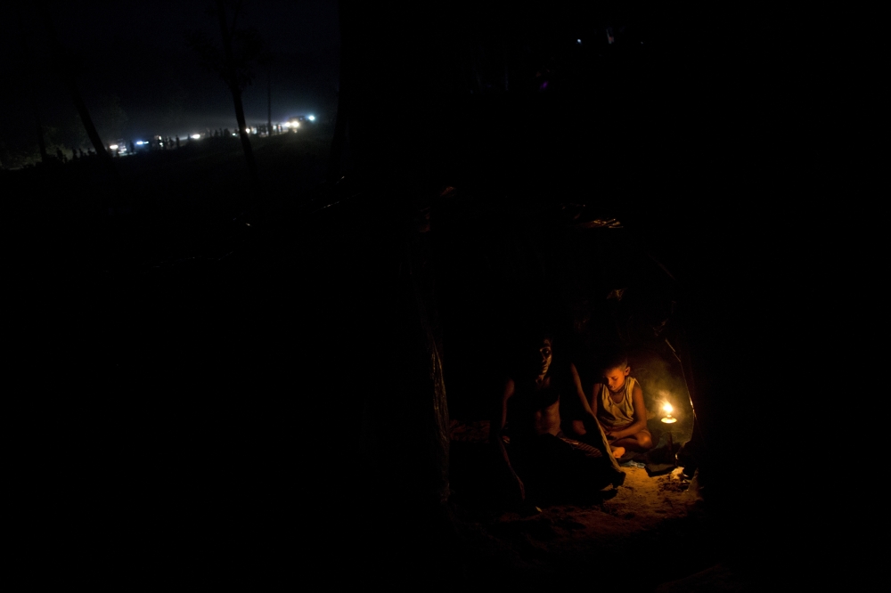 Rohingya Muslims rest inside a new tent next to Kutupalong refugee camp in Ukhia, Bangladesh, Tuesday, Sept. 5, 2017. Bangladesh, one of the world's poorest countries, was already sheltering some 100,000 Rohingya refugees before another 123,000 flooded in after Aug. 25, according to the U.N. refugee agency's latest estimate on Tuesday. (AP Photo/Bernat Armangue)