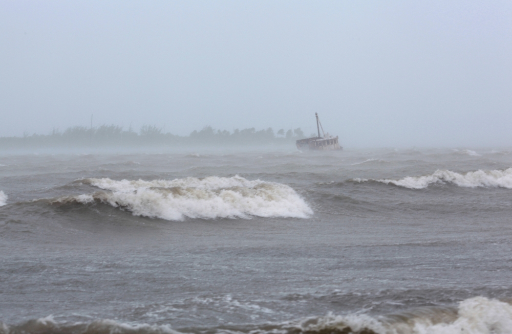 Waves battle a stranded ship as Hurricane Irma slammed across islands in the northern Caribbean on Wednesday, in Fajardo, Puerto Rico September 6, 2017.  REUTERS/Alvin Baez