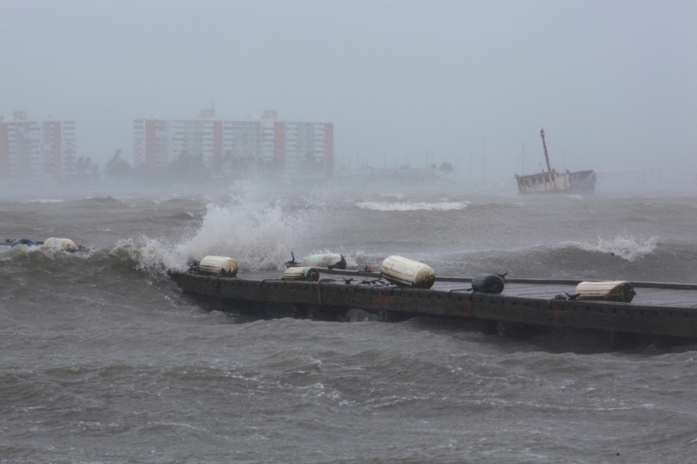 Waves break over a dock as Hurricane Irma slammed across islands in the northern Caribbean on Wednesday, in Fajardo, Puerto Rico September 6, 2017. REUTERS/Alvin Baez