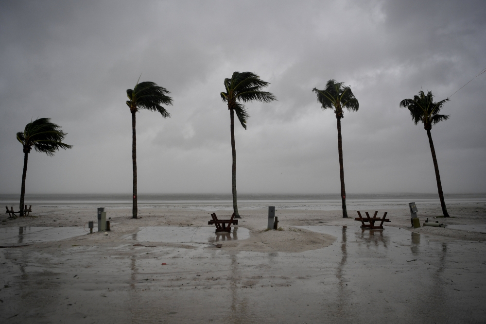 Palm trees sway as the wind blows and water rises at an evacuated recreational vehicle park as hurricane Irma approaches Fort Myers Beach, Florida, U.S., September 10, 2017. REUTERS/Bryan Woolston