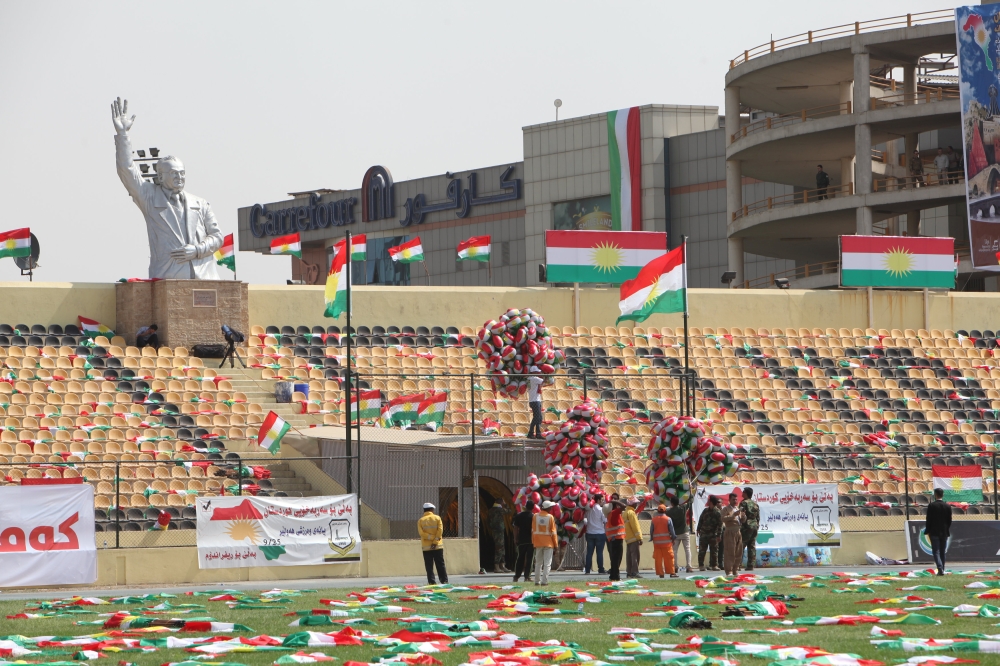 People carry the flags of Kurdistan before the start of a rally calling to vote yes in the coming referendum, in Erbil, Iraq September 22, 2017. REUTERS/Azad Lashkari