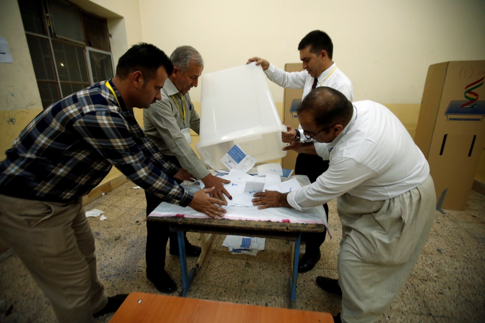 Officials empty a ballot box after the close of the polling station during Kurds independence referendum in Erbil, Iraq September 25, 2017. REUTERS/Azad Lashkari