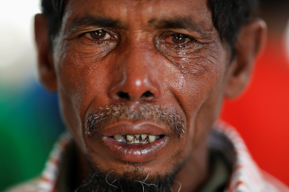 Lalu Miya cries over the bodies of his wife and children, who died after a boat with Rohingya refugees capsized as they were fleeing Myanmar, before the funeral just behind Inani Beach near Cox's Bazar, Bangladesh September 29, 2017. Miya, whose family was on the boat that capsized, just off the shore of Bangladesh, survived but three of his children and wife died in the accident. Two other of his children remain missing. REUTERS/Damir Sagolj