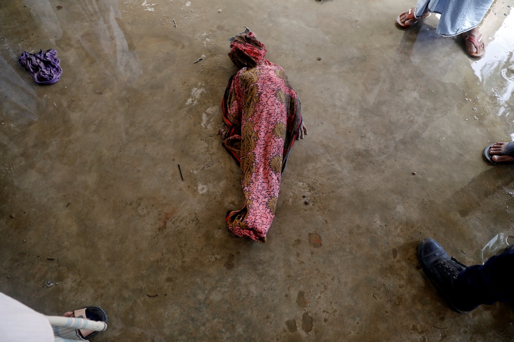 ATTENTION EDITORS - VISUAL COVERAGE OF SCENES OF DEATH One of the Rohingya refugee children's bodies who died, after their boat capsized as they were fleeing from Myanmar, is prepared for the funeral, just behind the Inani Beach near Cox's Bazar, Bangladesh September 29, 2017. REUTERS/Damir Sagolj