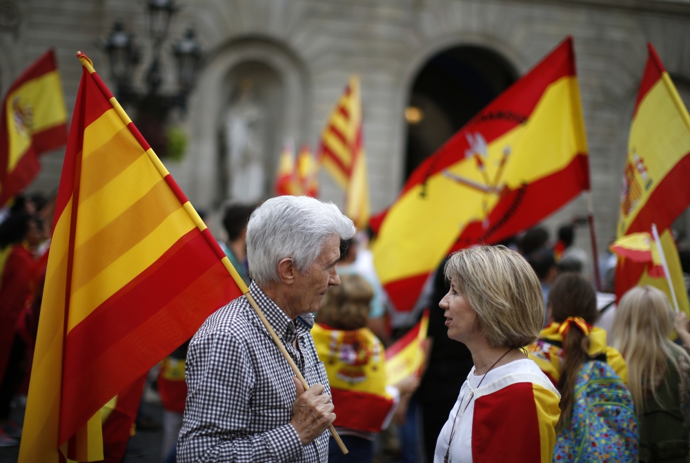 People carrying Spanish flags demonstrate against Catalonia's planned referendum on secession in Barcelona Saturday, Sept. 30 2017. The planned referendum is due to be held Sunday by the pro-independence Catalan government but Spain's government calls the vote illegal, since it violates the constitution, and the country's Constitutional Court has ordered it suspended. (AP Photo/Manu Fernandez)