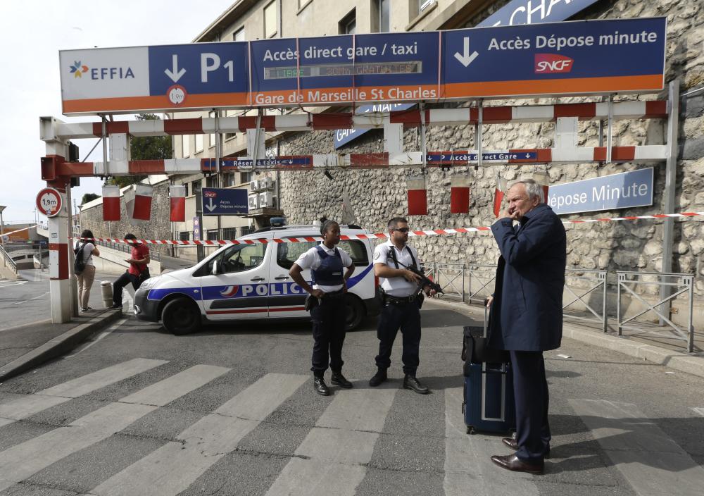 French police officers patrol outside the Marseille railway station, Sunday, Oct. 1, 2017. French police warn people to avoid Marseille's main train station amid reports of knife attack, assailant shot dead. (AP Photo/Claude Paris)