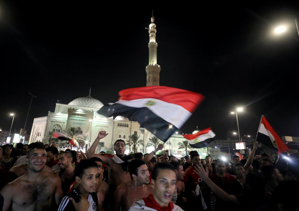 Egyptians celebrate their victory in a soccer match against Congo that qualifies Egypt for the World Cup, in Cairo, Egypt October 8, 2017. REUTERS/Mohamed Abd El Ghany