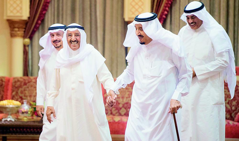 الملك سلمان ممسكا بيد أخيه الشيخ صباح الأحمد لدى استقباله أمس في الرياض. (واس)