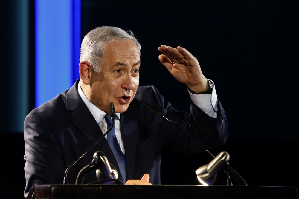 Israeli Prime Minister Benjamin Netanyahu delivers a speech during an event marking 50 years of Israeli settlements in the Jordan Valley on October 19, 2017, near the Maale Efraim settlement in the occupied West Bank.  / AFP / GALI TIBBON
