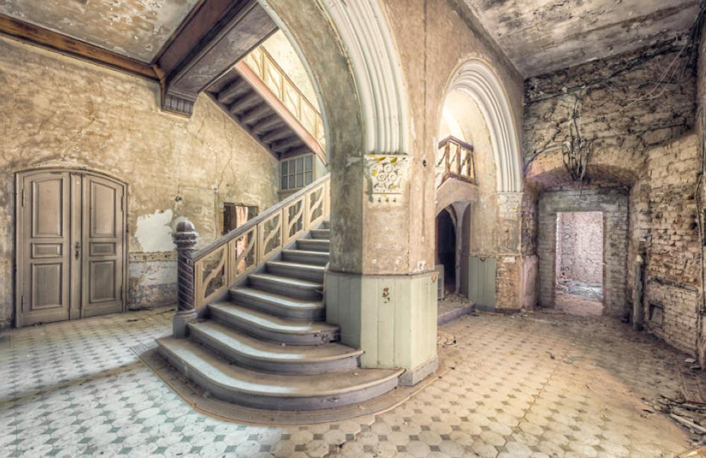 old abandoned staircase with pillar and arch