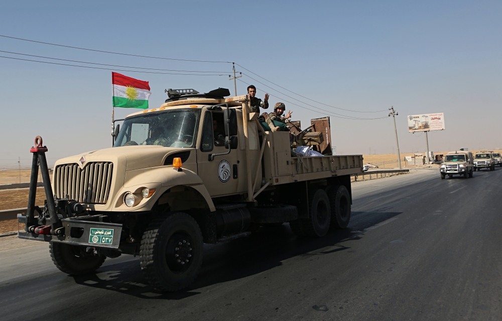 Kurdish security forces head to Alton Kupri, on the outskirts of Irbil, Iraq, Friday Oct. 20, 2017. Iraqi and Kurdish forces are exchanging fire at the border between federal and Kurdish lands, days after Kurds withdrew from disputed territories across northern Iraq. (AP Photo/Khalid Mohammed)