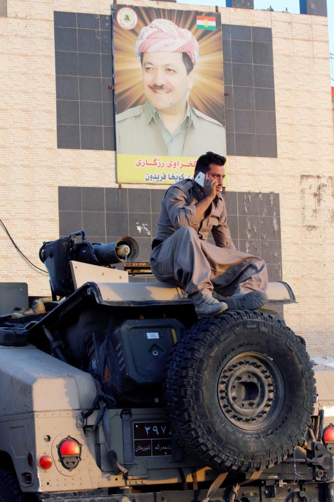 A member of the Kurdish Peshmerga fighters uses his phone, north of Kirkuk, Iraq October 19, 2017. REUTERS/Ako Rasheed