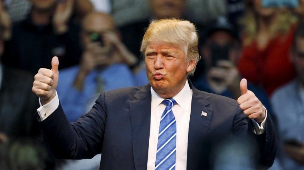 U.S. Republican presidential candidate Donald Trump reacts to supporters at the start of a Trump for President campaign rally in Raleigh, North Carolina December 4, 2015. Trump is making a campaign stop in the North Carolina capital. REUTERS/Jonathan Drake - RTX1X9KJ