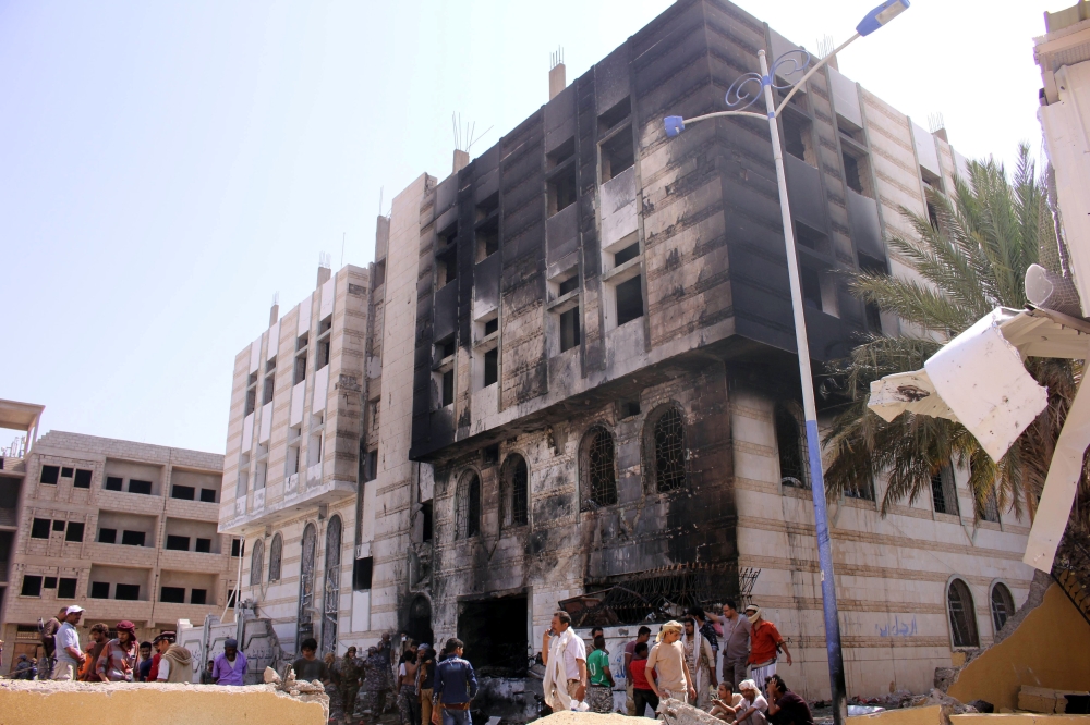 People gather at the site of a suicide car bomb attack outside a police forces camp in Aden, Yemen, November 14, 2017. REUTERS/Fawaz Salman