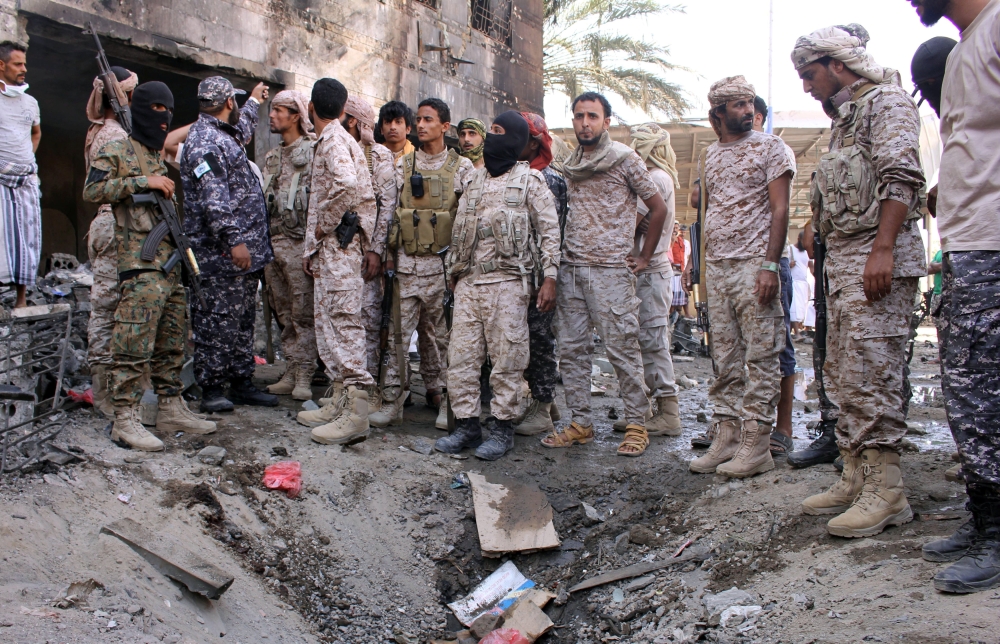 Members of security forces organized by the Saudi-led coalition gather at the site of a suicide car bomb attack outside a police forces camp in Aden, Yemen, November 14, 2017. REUTERS/Fawaz Salman