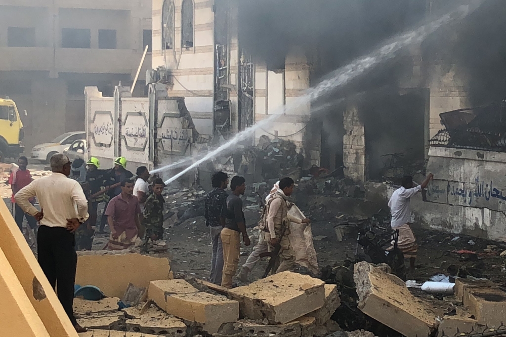 Yemeni firefighters douse flames following an explosion near a security post in the southern port city of Aden on November 14, 2017.  / AFP / NABIL HASSAN
