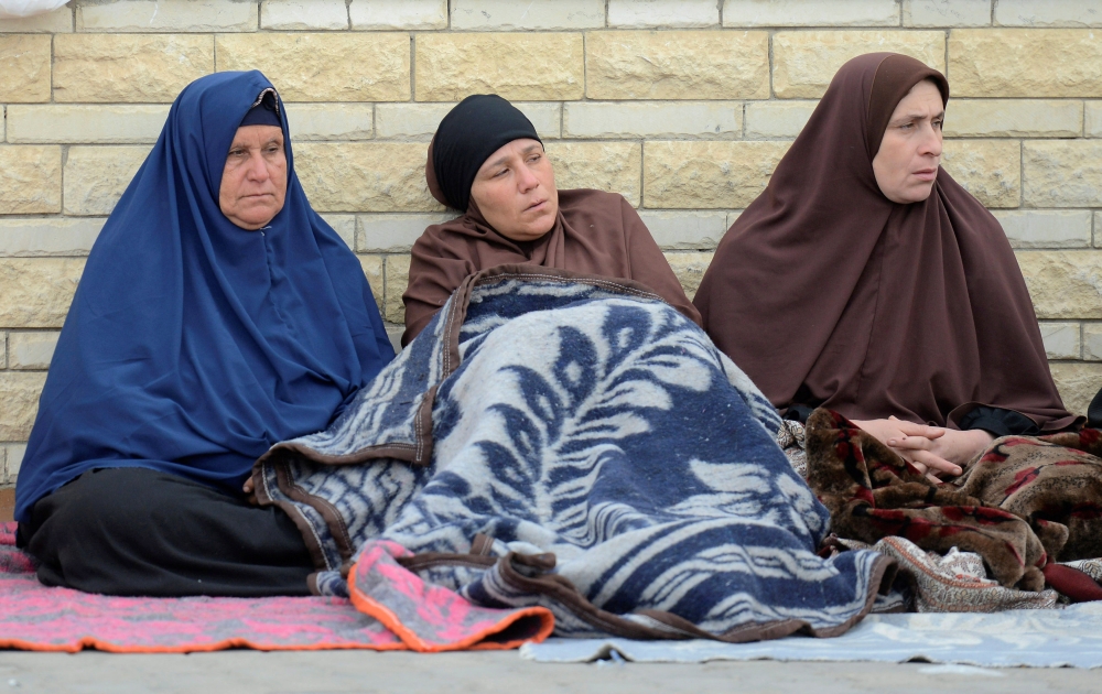 Relatives of victims of the explosion at Al-Rawda mosque, sit outside Suez Canal University hospital in Ismailia, Egypt November 25, 2017. REUTERS/Amr Abdallah Dalsh