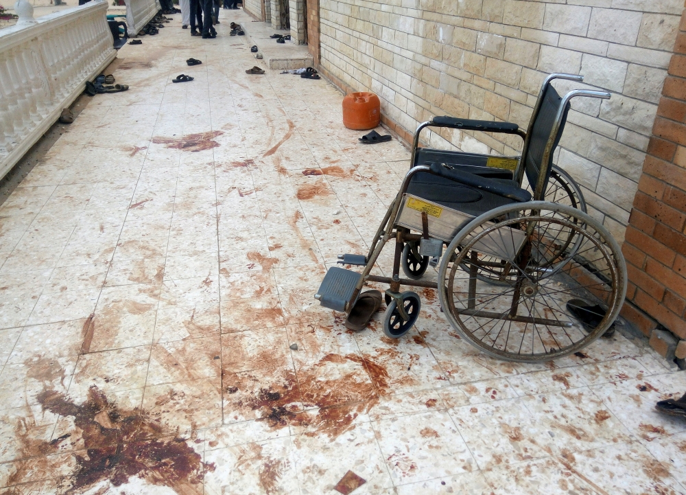 ATTENTION EDITORS - VISUALS COVERAGE OF SCENES OF DEATH AND INJURY??A wheelchair is seen near blood stains of victims after an explosion at Al Rawdah mosque in Bir Al-Abed, Egypt November 25, 2017. REUTERS/Mohamed Soliman TEMPLATE OUT