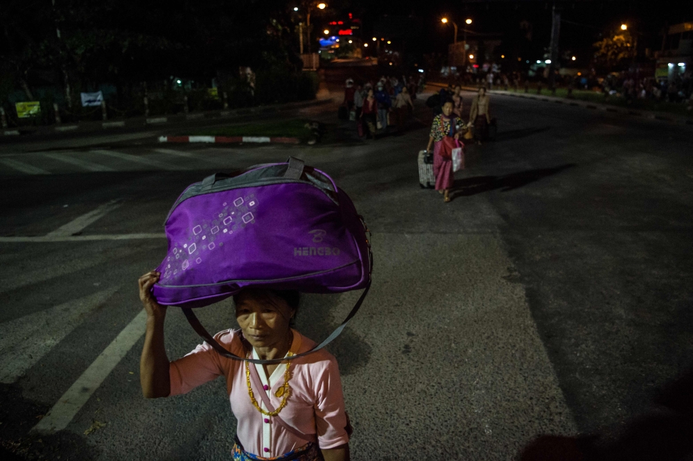 Ethnic Kachin Catholic faithful head to a church after arriving at the railway station in Yangon on November 25, 2017, ahead of the arrival of Pope Francis next week. Pope Francis arrives in Myanmar on November 27, locked in the headwinds of global outcry over the country's treatment of its minority Muslim Rohingya, some 620,000 of whom have been driven out of Rakhine state since August. / AFP / YE AUNG THU
