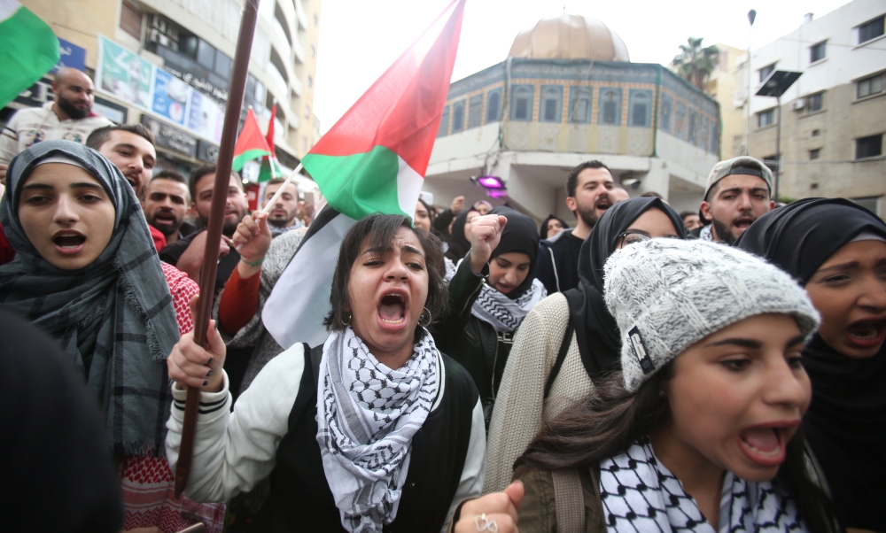 Protestors chant slogans and hold Palestinian flags in Sidon, southern Lebanon, December 7, 2017. REUTERS/Ali Hashisho