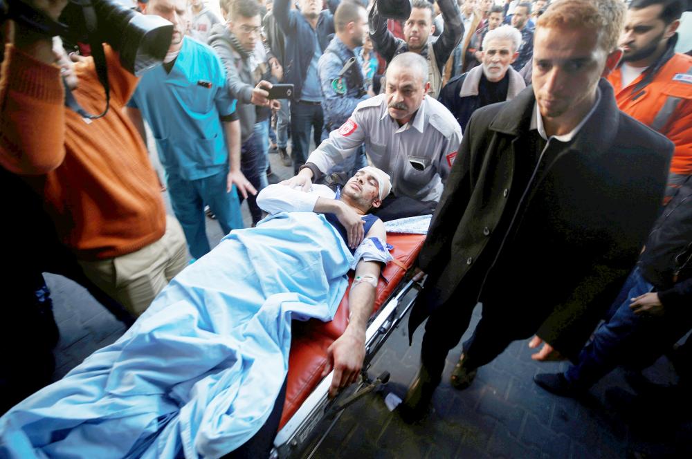 ATTENTION EDITORS - VISUAL COVERAGE OF SCENES OF INJURY OR DEATH A Palestinian, who was wounded during clashes with Israeli troops, is brought into a hospital as Palestinians call for a 