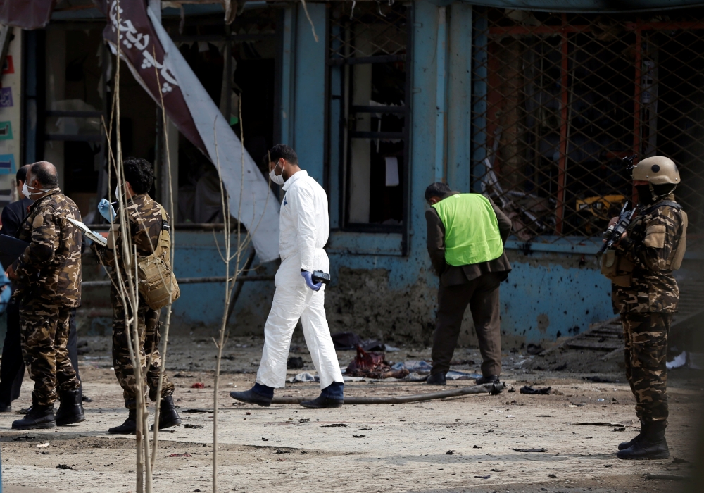 Afghan officials investigate the site of a suicide bomb attack near a Shi'ite mosque in Kabul, Afghanistan March 9, 2018. REUTERS/Omar Sobhani