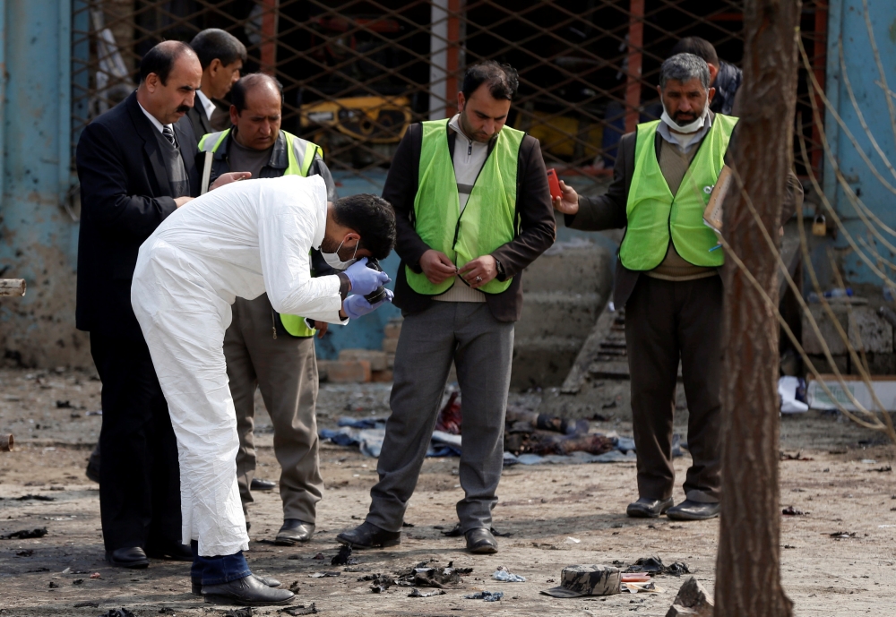 Afghan officials investigate the site of a suicide bomb attack near a Shi'ite mosque in Kabul, Afghanistan March 9, 2018. REUTERS/Omar Sobhani