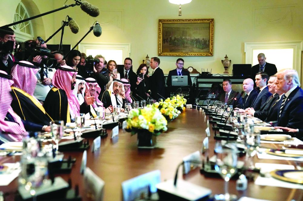 U.S. President Donald Trump and Saudi Arabia's Crown Prince Mohammed bin Salman sit down to a working lunch with their delegations at the White House in Washington, U.S. March 20, 2018.  REUTERS/Jonathan Ernst