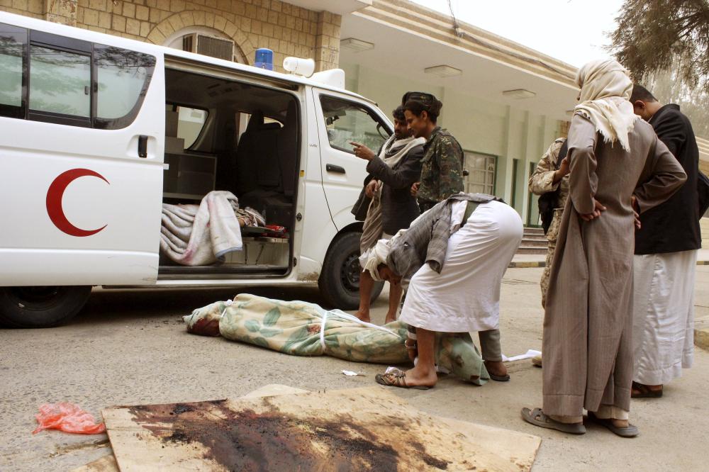 ATTENTION EDITORS - VISUAL COVERAGE OF SCENES OF INJURY OR DEATH 

A man wraps the body of a relative, killed in an air strike on a market place in Yemen's northwestern province of Saada March 27, 2015. Warplanes hit Yemen's Houthi-controlled capital and the Shi'ite Muslim group's northern heartland on Friday, the second day of a Saudi-led campaign to stop the militia establishing its rule across the country. REUTERS/Naiyf Rahma
TEMPLATE OUT	

