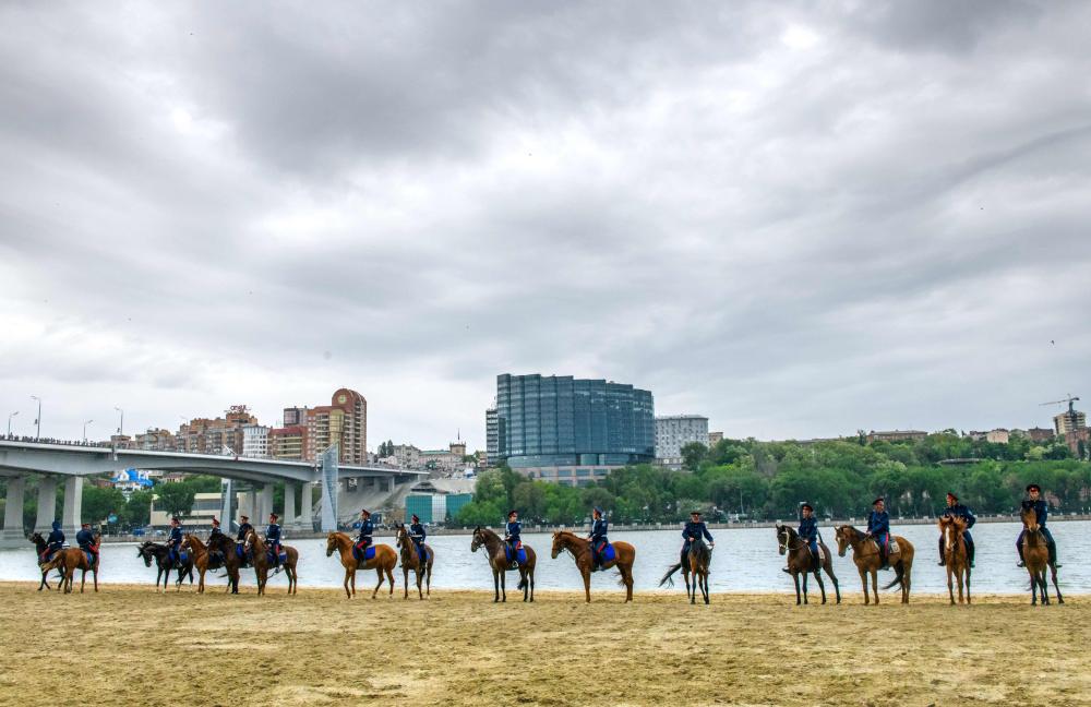 Don Cossacks practise their riding skills on the left bank of Don river outside Rostov Arena in the southern Russian city of Rostov-on-Don on May 13, 2018. Rostov-on-Don is one of the 11 host cities for the 2018 FIFA World Cup football tournament. / AFP / Mladen ANTONOV
