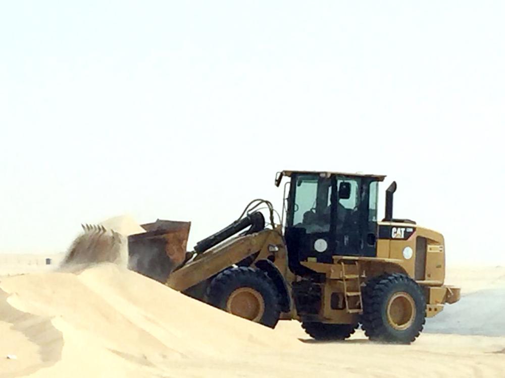 



آلية البلدية خلال إزالة الرمال. (عكاظ)