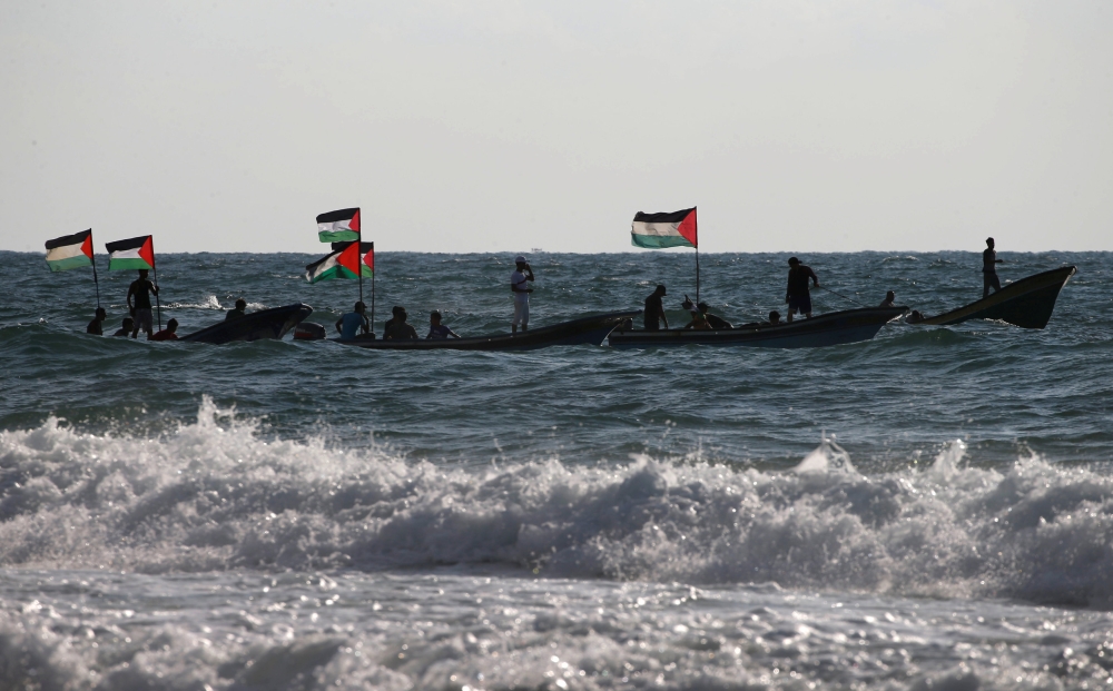 Palestinians ride boats during a protest against the Israeli blockade on Gaza, at the sea in Gaza August 18, 2018. REUTERS/Mohammed Salem