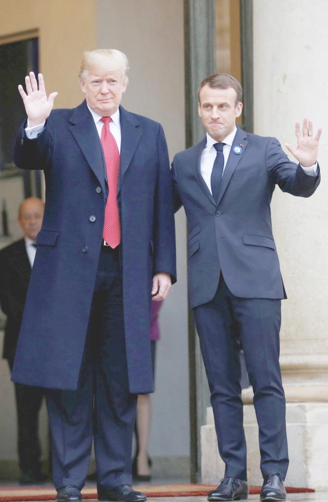



 ماكرون مستقبلا ترمب في قصر الإليزيه في باريس أمس. (رويترز)