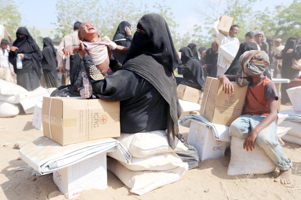 A boy cries as he waits with his mother at an ICRC aid distribution centre in Bajil, Yemen December 13, 2018, 2018. Picture taken December 13, 2018. REUTERS/Abduljabbar Zeyad TPX IMAGES OF THE DAY