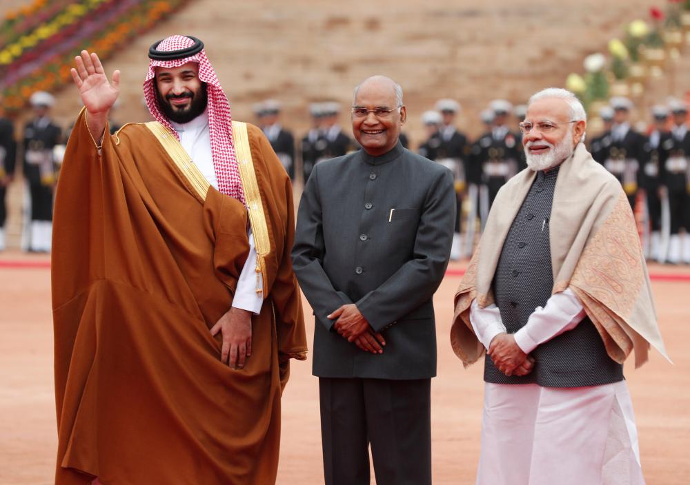 Saudi Arabia's Crown Prince Mohammed bin Salman waves next to India's President Ram Nath Kovind and Prime Minister Narendra Modi during his ceremonial reception at the forecourt of Rashtrapati Bhavan presidential palace in New Delhi, India, February 20, 2019. REUTERS/Adnan Abidi