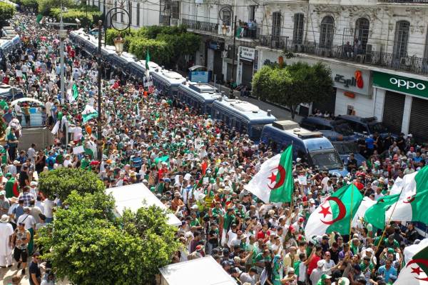 Algerian protesters gather during the 21st consecutive weekly Friday demonstration in the capital Algiers on July 12, 2019. Thousands of people protested for the 21st consecutive week in Algeria's capital, after a long night of celebrations as their national football team qualified for the 2019 Africa Cup of Nations semi-finals in Egypt. / AFP / -
