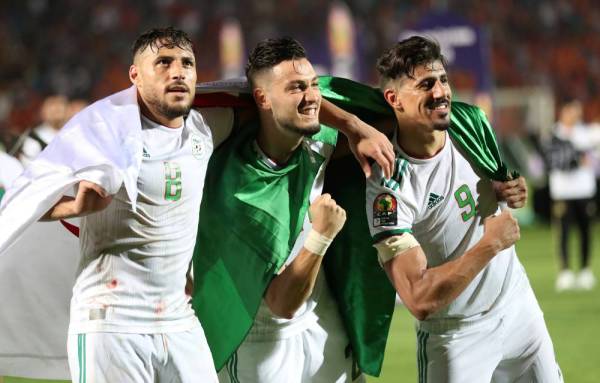 Soccer Football - Africa Cup of Nations 2019 - Final - Senegal v Algeria - Cairo International Stadium, Cairo, Egypt - July 19, 2019    Algeria's Youcef Belaili, Ramy Bensebaini and Baghdad Bounedjah celebrate winning the Africa Cup of Nations   REUTERS/Suhaib Salem