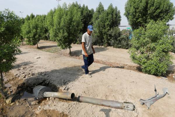 A man looks at a rocket that flew away after a weapons depot of an Iraqi militia group caught fire, in Baghdad, Iraq August 13, 2019. REUTERS/Khalid al-Mousily
