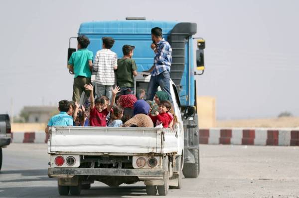 



 شاحنة تحمل سوريين فارين من العدوان التركي في بلدة تل أبيض أمس.  (رويترز)